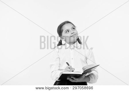Child School Uniform Kid Doing Homework. Child Girl School Uniform Clothes Hold Book And Pen. Girl C