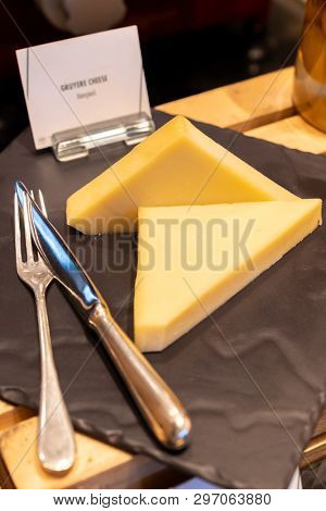 gruyere cheese on black stone plate in buffet line