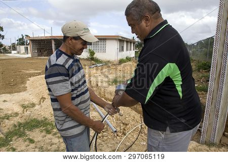 Cerro Goldo, Bayamon/puerto Rico - February 22, 2019: Two Men Work On Wiring At A Building Construct