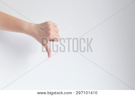 A Hand Signs Gesture Thumb Down; Meaning Dislike, Unlike, Disagree Or Fail On White Background.