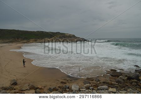 Person Fishing On A Cloudy Day On Big Beach In Colares. Nature, Architecture, History, Street Photog