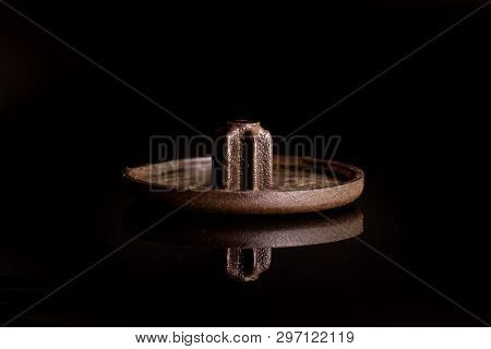 One Whole Brown Plast Masking Plug Work Item Isolated On Black Glass