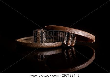 Group Of Two Whole Brown Plast Masking Plugs Work Item Isolated On Black Glass