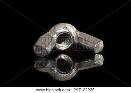 Closeup Of One Whole Metal Wingnut Work Item Isolated On Black Glass