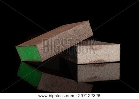 Group Of Two Whole Green And Grey Abrasive Block Sponges Work Item Isolated On Black Glass