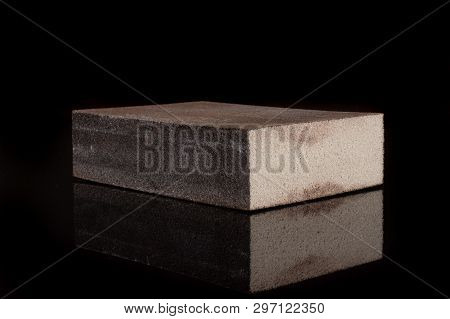 One Whole Grey Abrasive Block Sponge Work Item Isolated On Black Glass