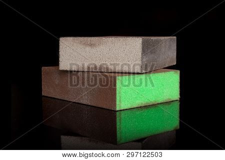 Group Of Two Whole Work Item Grey And Green Abrasive Block Sponges Isolated On Black Glass