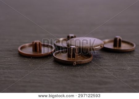 Group Of Five Whole Brown Plast Plugs Work Item On Grey Stone