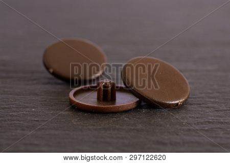 Group Of Three Whole Brown Plast Plugs Work Item On Grey Stone