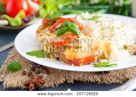 Chicken Fillet Baked In Cheese With Rice And Vegetables. Fired Cordon Bleu Chicken Served With Rice 
