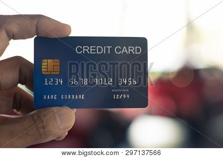 Man Holding Credit Card For Car Blurred Bokeh Background E-shopping