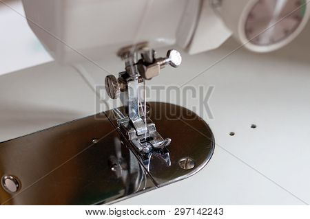 Shuttle With A Needle. Part Of An Electric Sewing Machine Close Up.