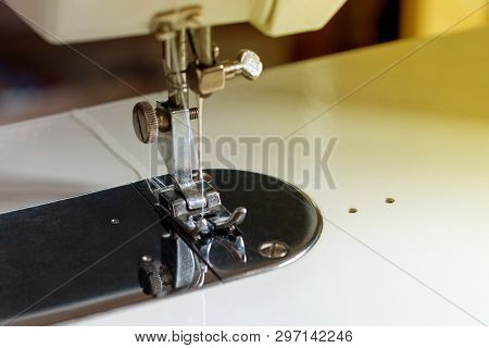 Shuttle With A Needle. Part Of An Electric Sewing Machine Close Up.
