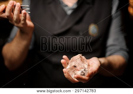 Close Shot Of Bartender Holding Ice With Ice Crusher