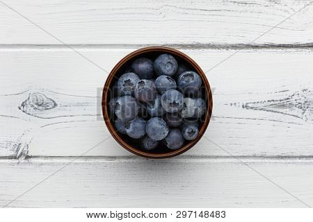 Blueberries In A Bowl On A Distressed White Wooden Background
