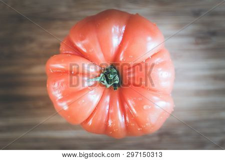 Oxheart Tomatoes. Tomato On A Bamboo Wood Plate.