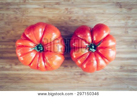 Oxheart Tomatoes. Tomatoes On A Bamboo Wood Plate.