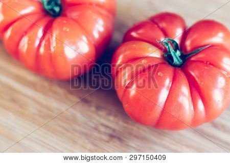 Oxheart Tomatoes. Tomatoes On A Bamboo Wood Plate.