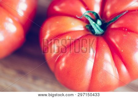 Oxheart Tomatoes. Tomatoes On A Bamboo Wood Plate.