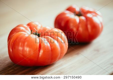 Oxheart Tomatoes. Tomatoes On A Bamboo Wood Plate.