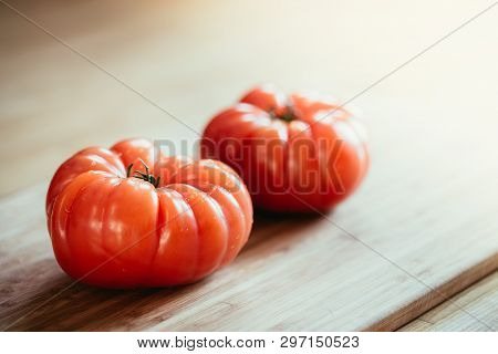Oxheart Tomatoes. Tomatoes On A Bamboo Wood Plate.