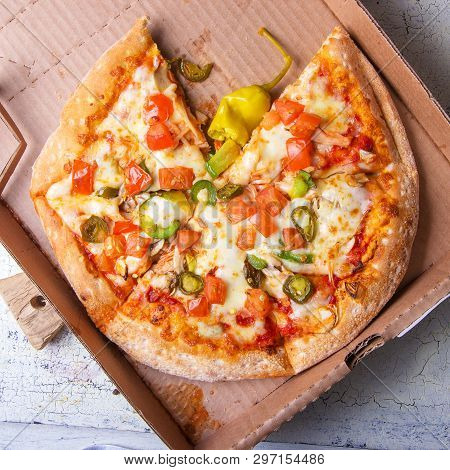 Tasty Italian Pizza Mexicano In A Box On Brown Concrete Background. Top View Of Hot Pizza With Jalap
