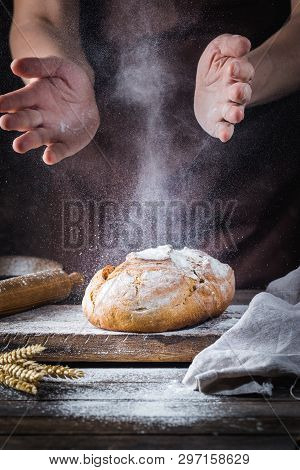 Baker Cooking Bread. Man Slaps Flour Over The Dough. Mans Hands Making Bread