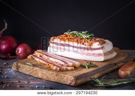 Chunks Of Salted Bacon On Dark Background. Healthy Food With Spices, Herbs Is Decorated Rosemary On