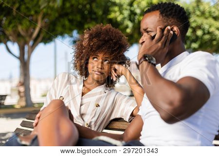 Outdoor Protrait Of Black African American Couple -  Girl Bored Watcing Boyfriend On Phone