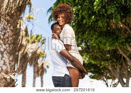 Outdoor Protrait Of Black African American Couple - Guy Carrying Girfriend On His Back