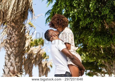 Outdoor Protrait Of Black African American Couple - Guy Carrying Girfriend On His Back