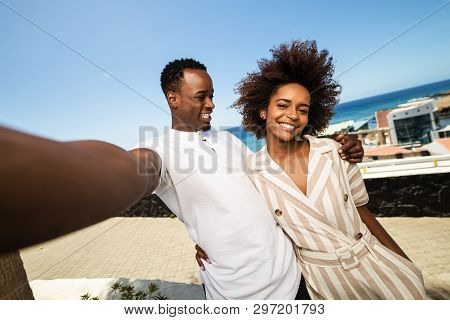 Outdoor Protrait Of Black African American Couple  Taking A Selfie