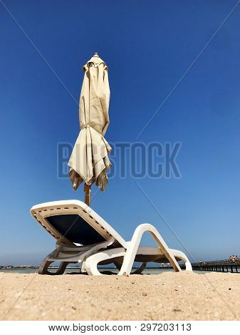 Stylish Lounger In Yellow Sand To Sun Sunbed On Beach In Summer Under Open Sky. Sunbed Intended For 