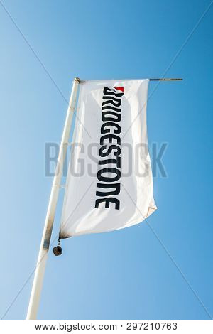 Sagunto, Spain - February 18, 2019: Bridgestone Flag With Logo On Clear Blue Sky Background Located 