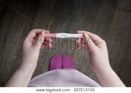 Tennage Girl Holding A Pregnancy Test. Personal Perspective With Copy Space.