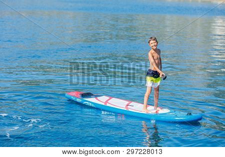 Paddle Boarder. Child Boy Paddling On Stand Up Paddleboard. Healthy Lifestyle. Water Sport, Sup Surf