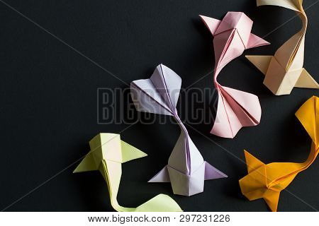 Handmade Paper Craft Origami Gold Koi Carp Fishes On Black Background.top View, Pattern