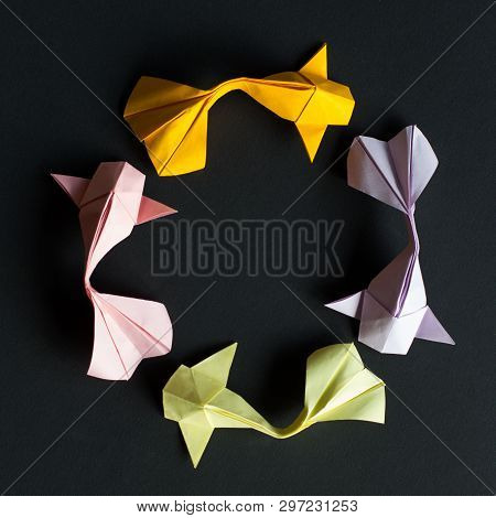 Handmade Paper Craft Origami Gold Koi Carp Fishes On Black Background.top View, Pattern