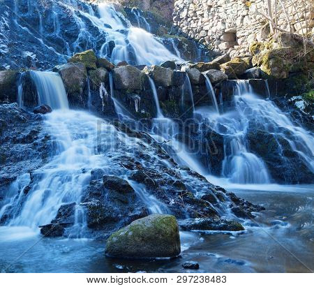 Beautful Waterfall In Blue Shades In The Swedish Village Rottle During Spring