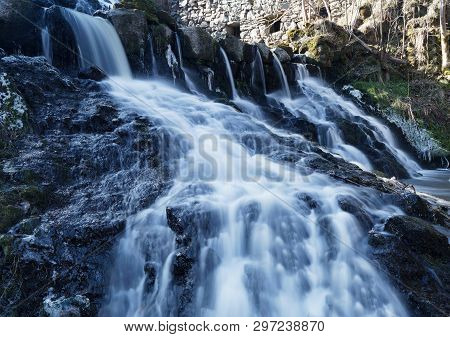 Beautful Waterfall And An Old Mill In The Swedish Village Rottle During Spring