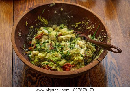 Homemade Italian Potato Gnocchi In Pesto Sauce With Arugula And Sundried Tomatoes