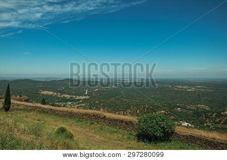 Countryside Landscape With Verdant Field And Stone Wall On Top Of Hill At Evoramonte. A Tiny Fortifi
