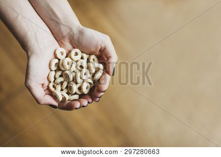 Sweet Cereal Loops In Hands. Corn Flakes For Breakfast. Space For Text