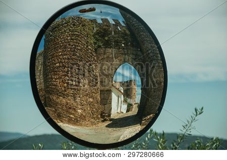 Stone Tower At The Main Entrance Doorway On A Sunny Day, Reflected In Street Mirror At Evoramonte. A