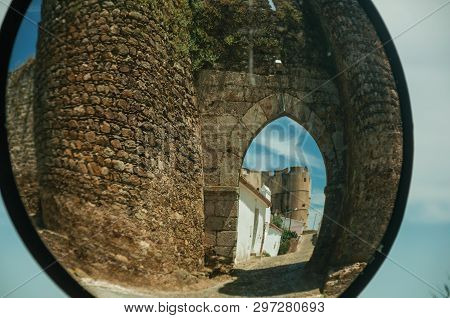 Stone Tower At The Main Entrance Doorway On A Sunny Day, Reflected In Street Mirror At Evoramonte. A
