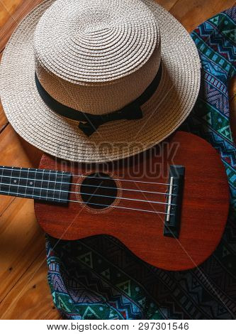 The Ukulele Put Beside Woven Hat, And Backpack, Trip,blurry Light Around, Strings, Coffee Ukulele
