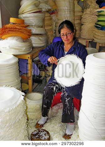 Cuenca, Ecuador - August 10, 2016: Woman Making Panama Hat Or Paja Toquilla Hat, Weaving From Straw,