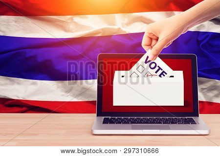 Online Vote , Poll, Exit Poll For Thailand General Election Concept. Close Up Hand Of A Person Casti