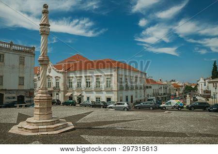Estremoz, Portugal - July 6, 2018. Pillory in the foreground on square with old buildings around in sunny day at Estremoz. A nice little historic town with several marble buildings on eastern Portugal
