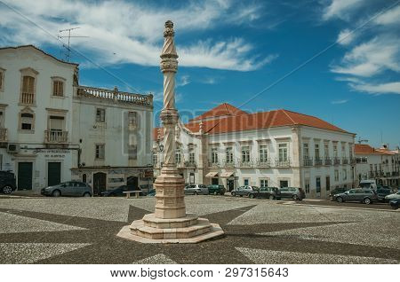 Estremoz, Portugal - July 6, 2018. Pillory in the foreground on square with old buildings around in sunny day at Estremoz. A nice little historic town with several marble buildings on eastern Portugal